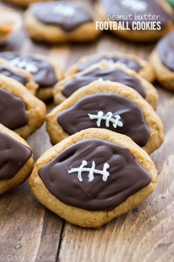 stack of football shaped peanut butter cookies with decorations on top