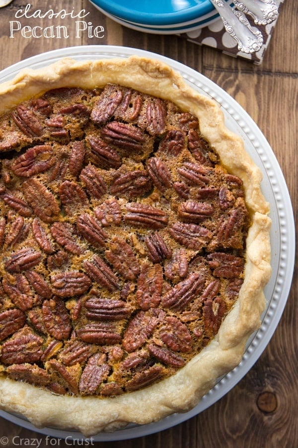 Pecan pie sitting o a white plate