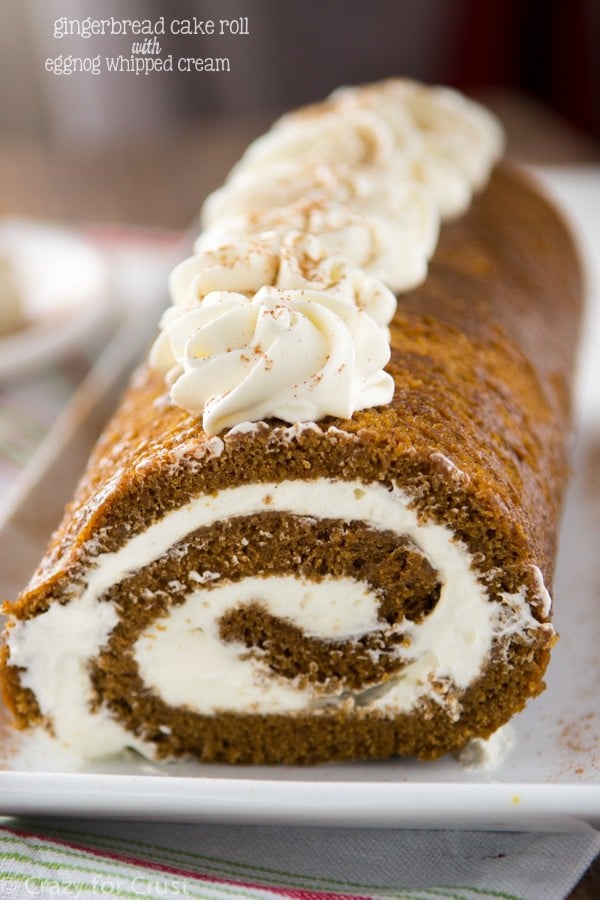 gingerbread cake roll with whipped cream on white platter