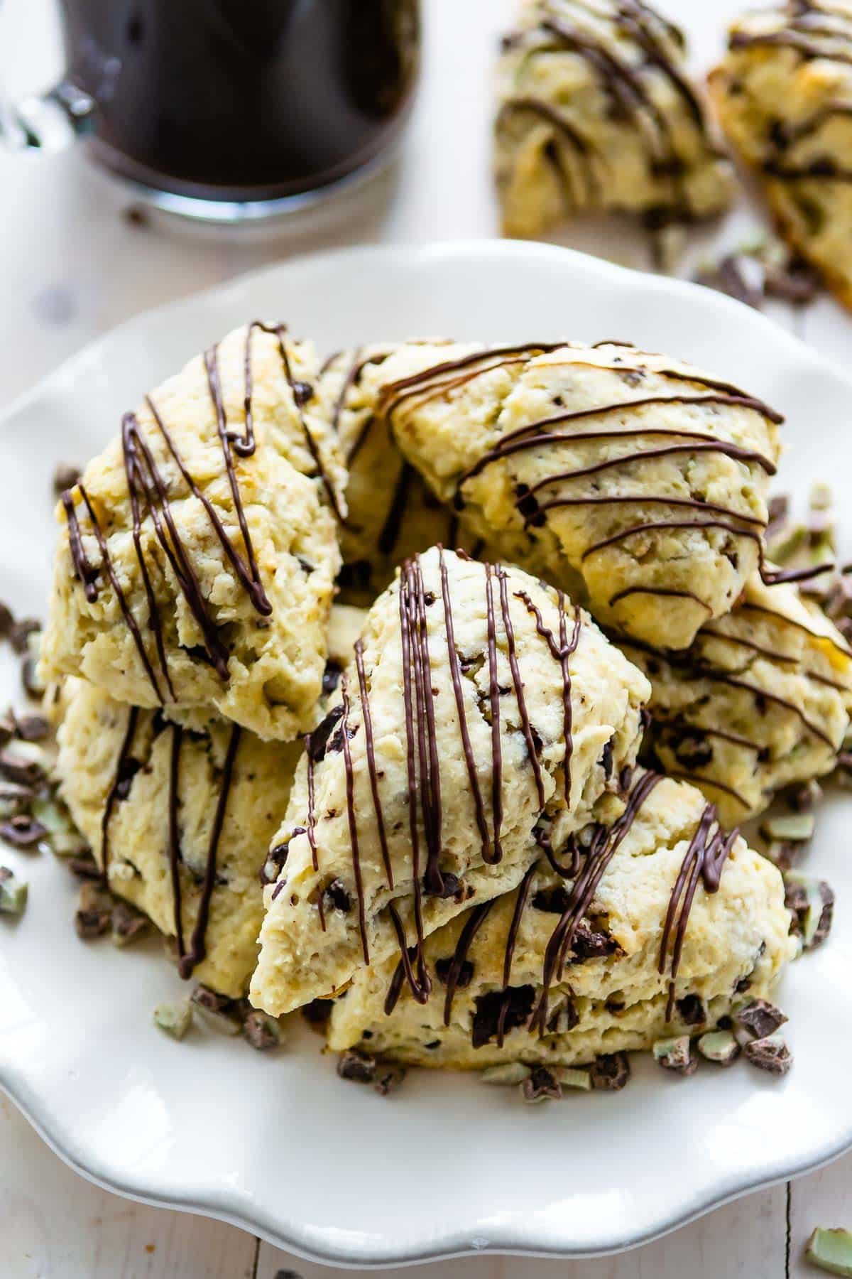 scones on a white plate with chocolate drizzled on top.