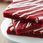 Red Velvet Blondies stacked on a cake stand