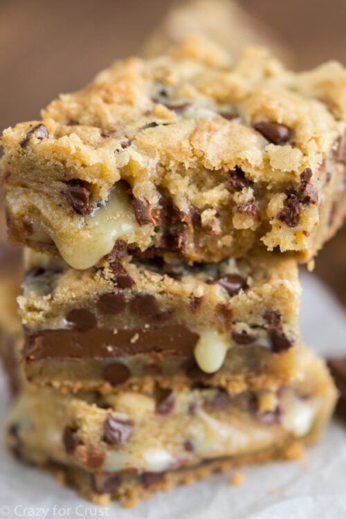 Stack of gooey bars on parchment paper