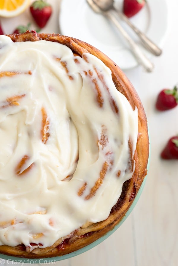 Giant Strawberry Cinnamon Roll Cake Recipe made with fresh strawberries and lemon cream cheese icing!