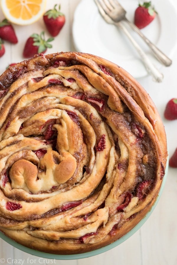 Giant Strawberry Cinnamon Roll Cake is the perfect breakfast or brunch recipe! It's an easier recipe than it looks, filled with fresh strawberries.