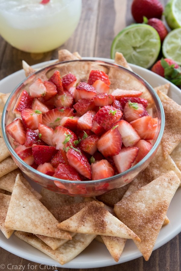 Strawberry Fruit Salsa with a hint of lime served with cinnamon sugar pie crust chips! This easy recipe is the perfect appetizer or snack!