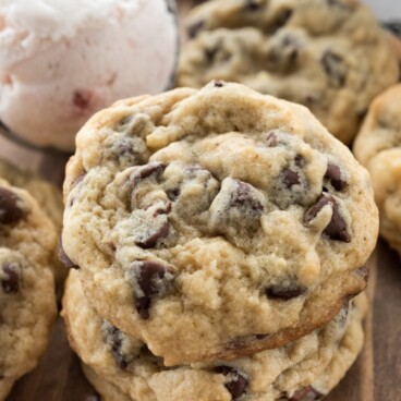 Stack of ice cream chocolate chip cookies on wood table with ice cream