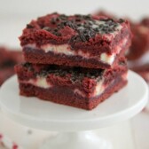 Red Velvet Gooey Bars on a white cake stand