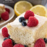 Slice of lemon snack cake topped with blueberries and raspberries