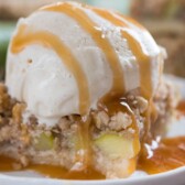 Slice of zucchini pie bar with ice cream and caramel drizzle on top