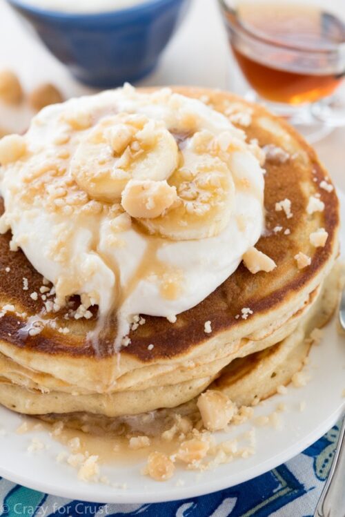 Buttermilk Pancakes with banana slices and maple syrup