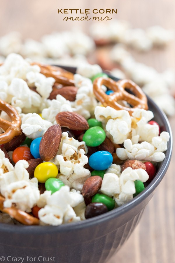 Kettle Corn Snack Mix with almonds! EASY homemade kettle corn is mixed with candy, almonds, and pretzels to make the perfect snack!