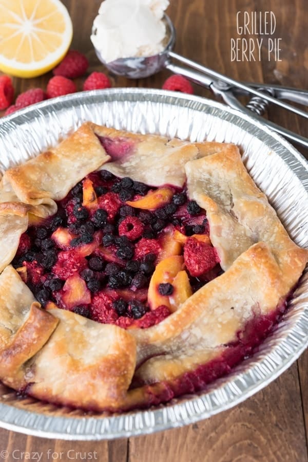 Learn how to grill a pie! This Grilled Berry Peach Pie Recipe is made on the BBQ for the perfect summer dessert!