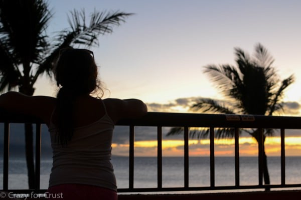 girl looking over balcony at sunset