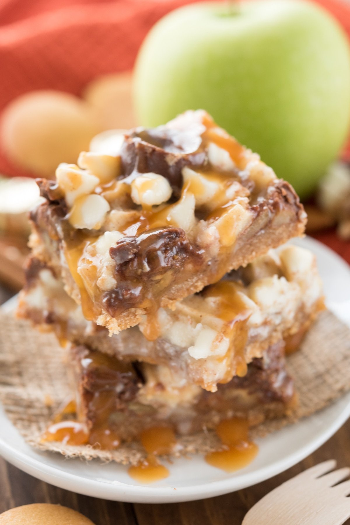 stack of magic bars with apples and caramel.