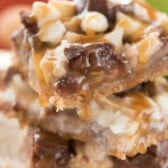 Stack of caramel apple pie magic bars on white plate