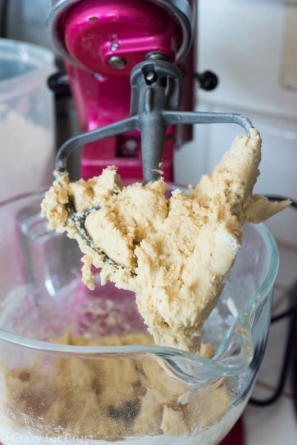 Process shot of snickerdoodle apple cobbler dough in pink kitchenaid mixer