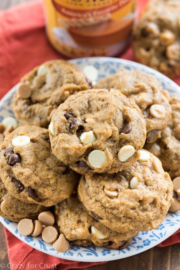 pumpkin cookies with white and chocolate chips on blue patterned plate