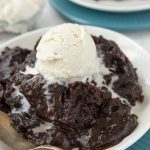 Slow Cooker Brownie Pudding on a white plate with a spoon