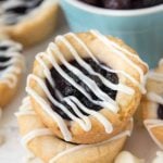 Stack of Blueberry Pie Cookies topped with white chocolate drizzle.