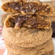 Stack of Salted caramel molasses cookies are chewy molasses cookies stuffed with salted caramel dark chocolate candies. The perfect Christmas cookie recipe!