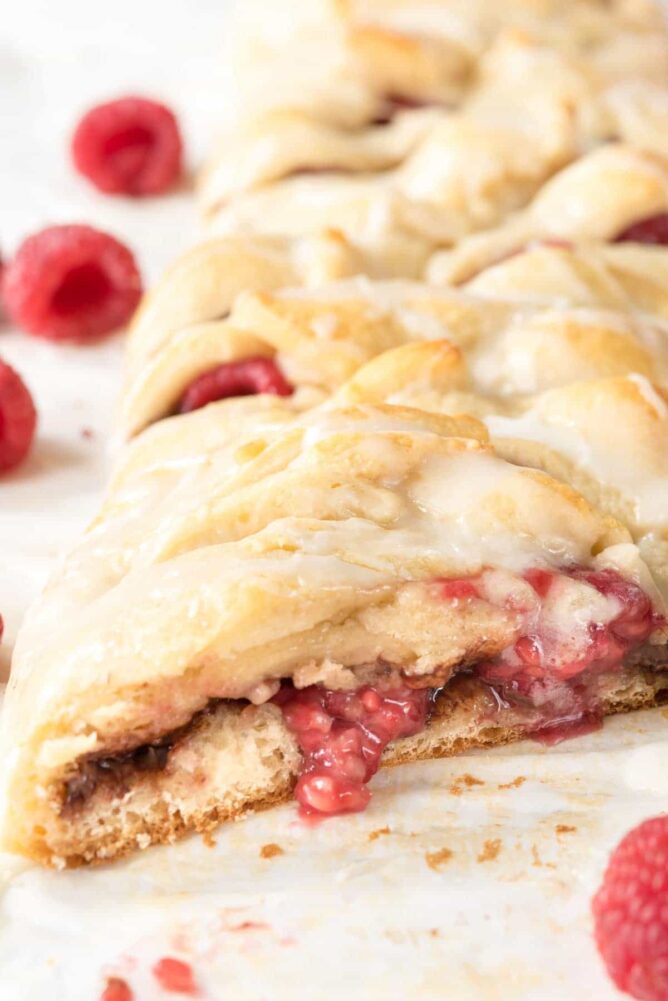 Blueberry Nutella Danish sliced open at the end sitting on parchment paper