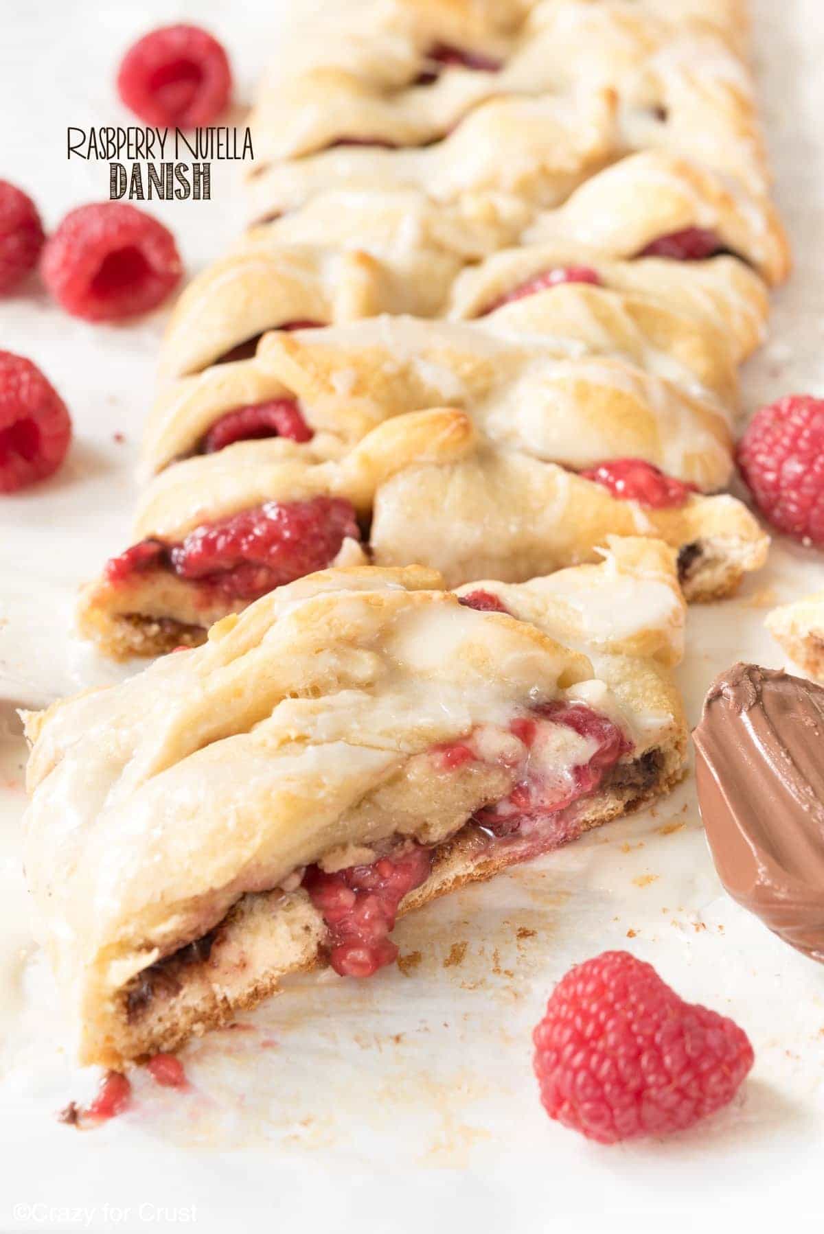 Easy Raspberry Nutella Danish Recipe - this breakfast pastry is so easy to make and is full of Nutella and raspberries!! Only 3 main ingredients and it's on the table in under 30 minutes!