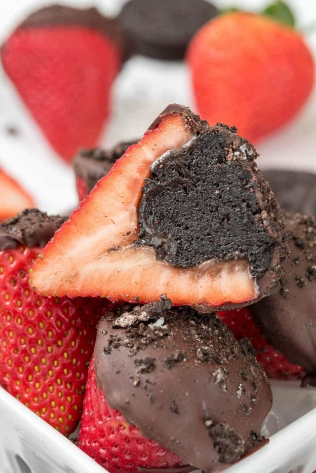 close up of strawberry filled with oreo truffle