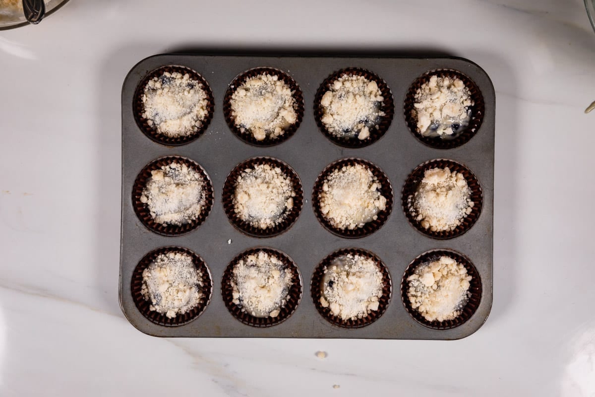 process shot of blueberry cream cheese muffins being made.