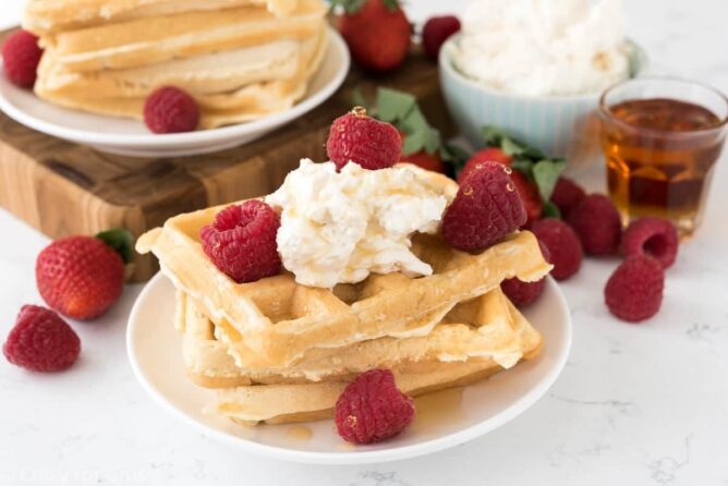 Cheesecake waffles with stacked on two white plates