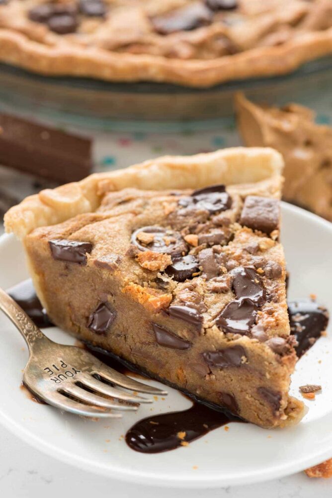 Slice of Kit Kat peanut butter pie on a white plate with a fork