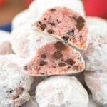 Strawberry chocolate chip snowball cookies in a blue bowl and split in half to show inside of cookie