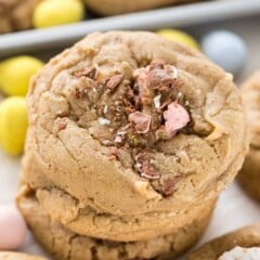 Stack of cadbury egg cookies with cadbury candies around it