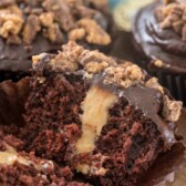 Peanut butter cup cupcake split in half to show peanut butter filling in middle