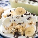 Closeup shot of piece of banana chocolate chip shortbread icebox cake on white and blue plate