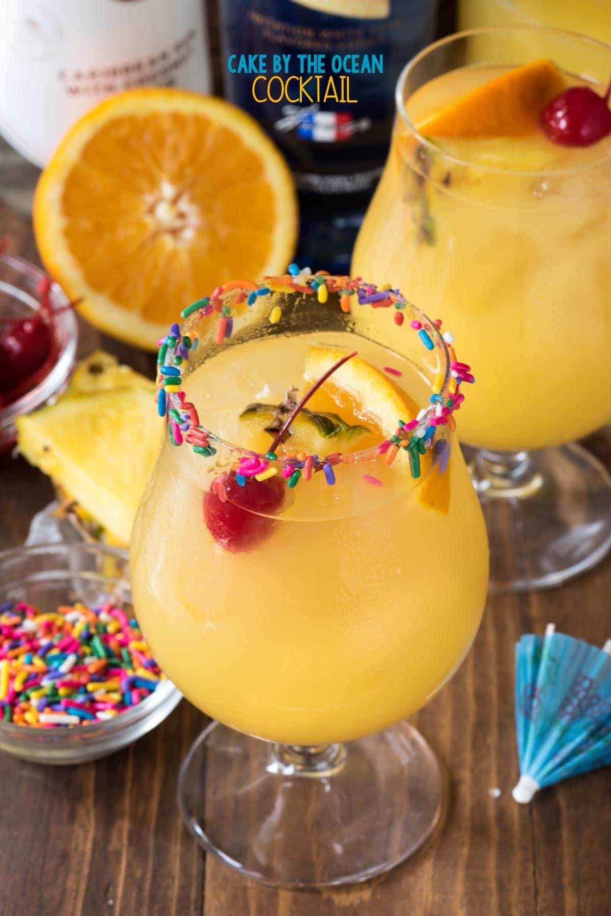 Cake by the Ocean Cocktail made with Cake Vodka, Coconut Rum, Orange and Pineapple Juices! You can whip up a pitcher of these in less than 5 minutes!