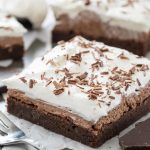 French silk brownie on parchment paper with chocolate shavings on top