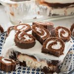 Piece of swiss roll layered no bake dessert on blue and white plate