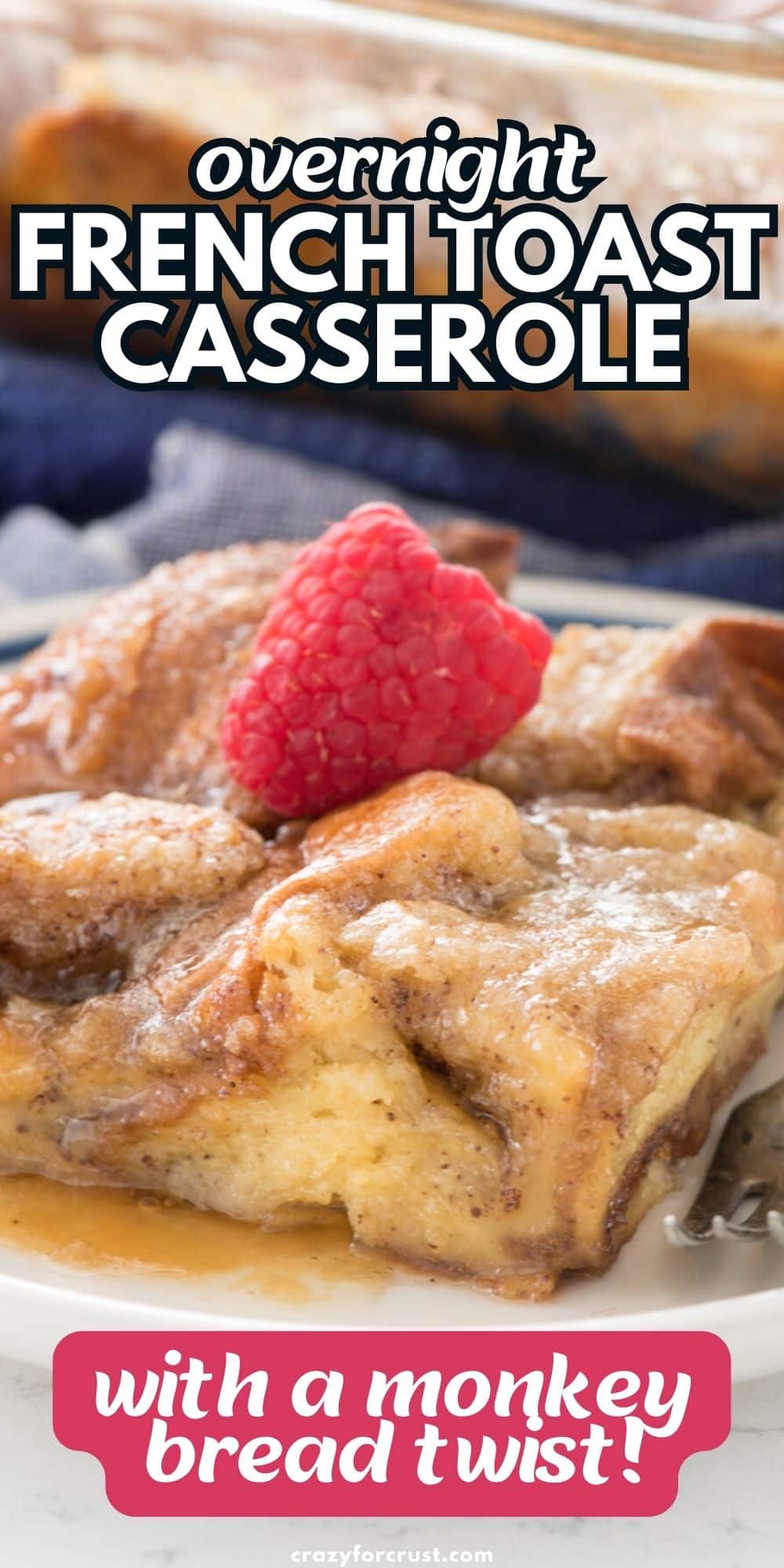 french toast casserole with syrup on white plate with fork and raspberry