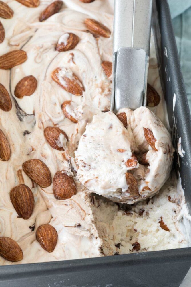 No churn almond fudge Ice cream being scooped out of dish