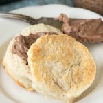 Southern style biscuit cut in half with chocolate spread in the middle