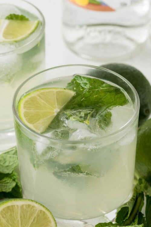 Mojito in a small cocktail glass with lime slices