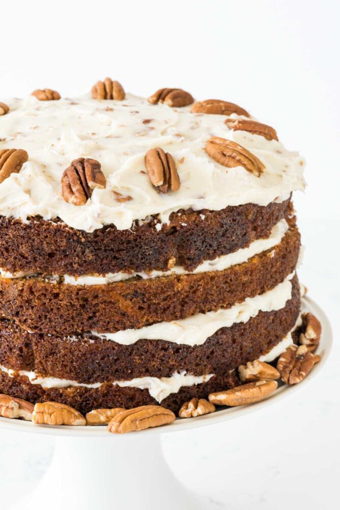 Naked Carrot Cake on a white cake stand