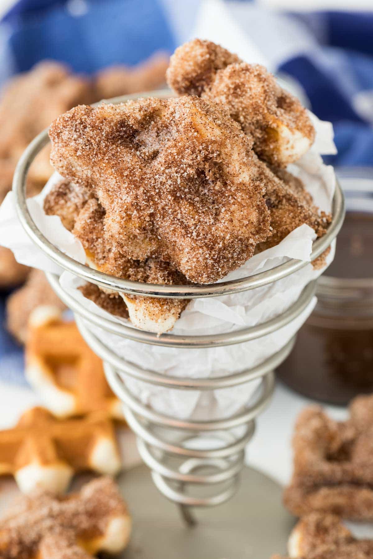 Easy Churro Bites - this churro recipe has only 4 ingredients and isn't fried. They're made in a waffle iron! Dip them in chocolate ganache for a sinful treat.