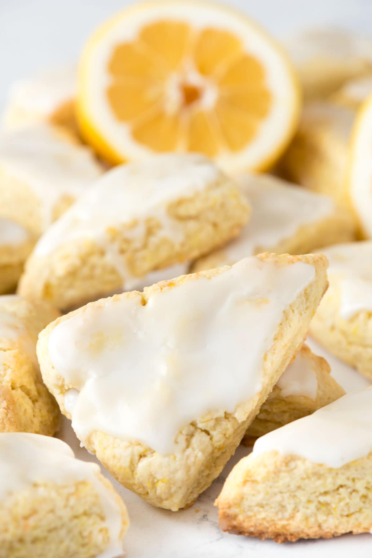 Mini Lemon Scones - this easy recipe stays soft for days! They're pillowy soft and FULL of lemon flavor, in the scone and in the glaze.