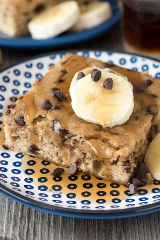 piece of chocolate chip banana pancake cake on a blue and white plate