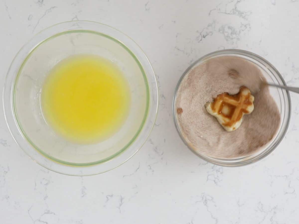 bowl of melted butter and bowl of cinnamon sugar with waffle biscuit inside.