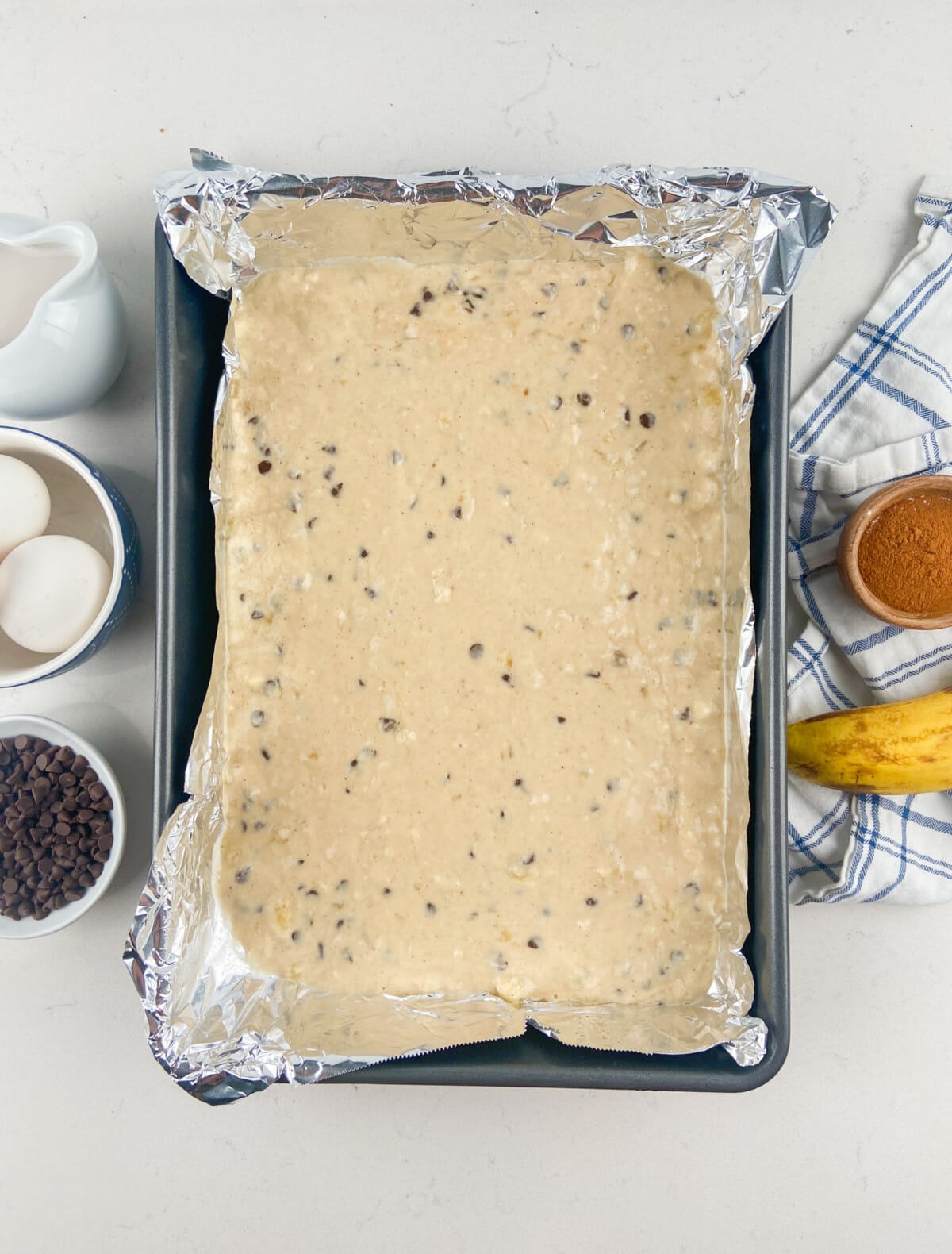 pancake batter in 9x13 pan with foil