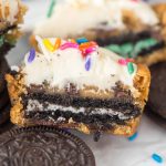 Frosted cupcookie split in half to show oreo cookie center