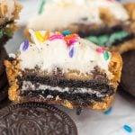 Frosted cupcookie split in half to show oreo cookie center
