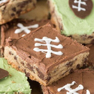 Chocolate chip cookie cake pieces with frosting and football decor